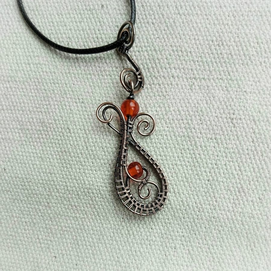 Pendant made of copper wire and bright glass beads