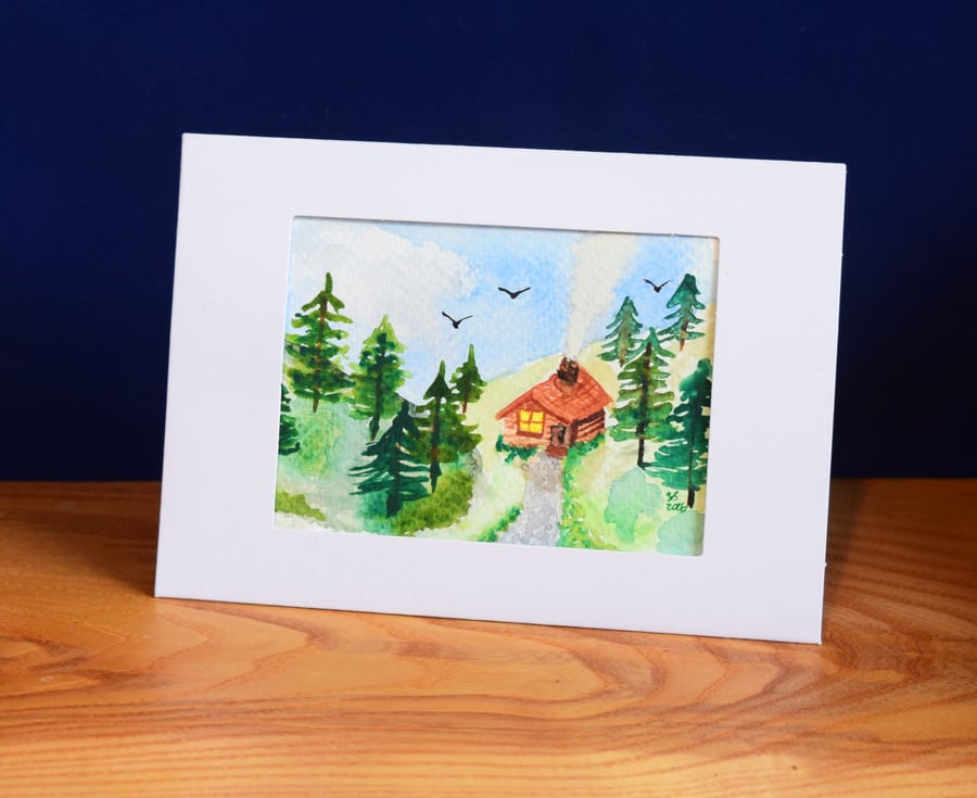 Cosy cabin in evergreen forest - watercolour greeting card, blank inside