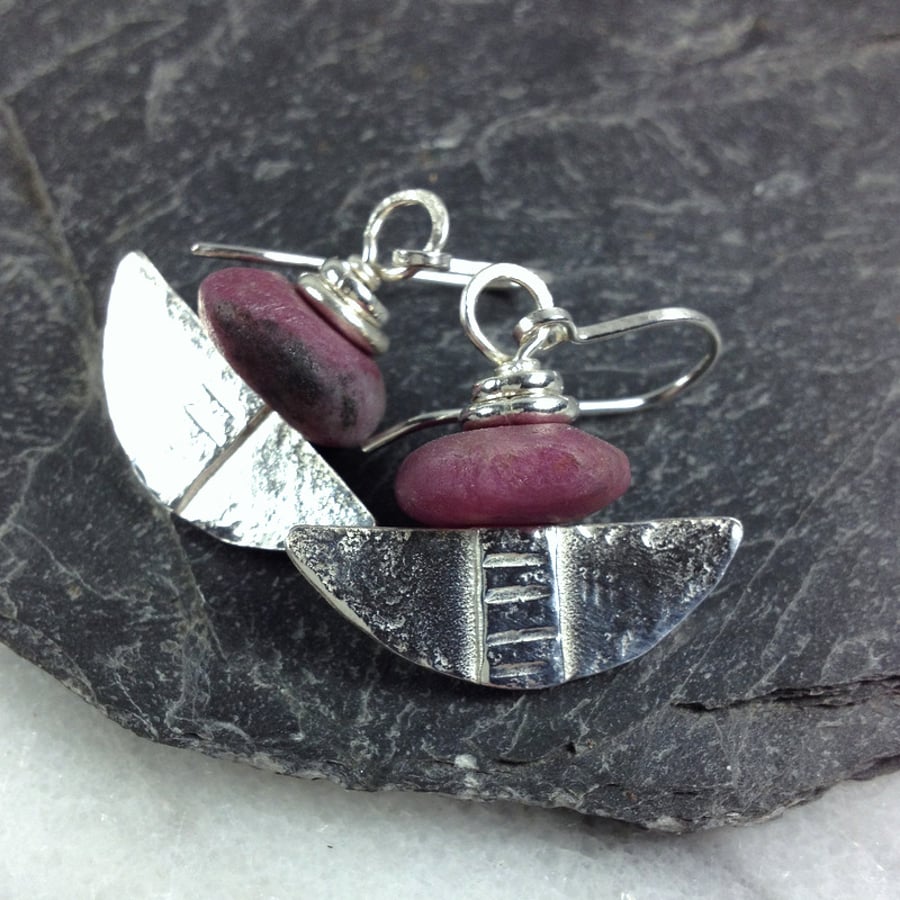 Silver and raw ruby tribal blade earrings.