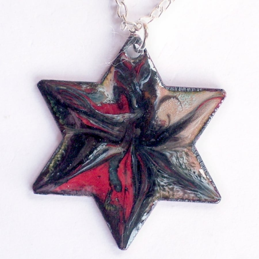 black and red on clear enamel scrolled on a 6 pointed star - pendant