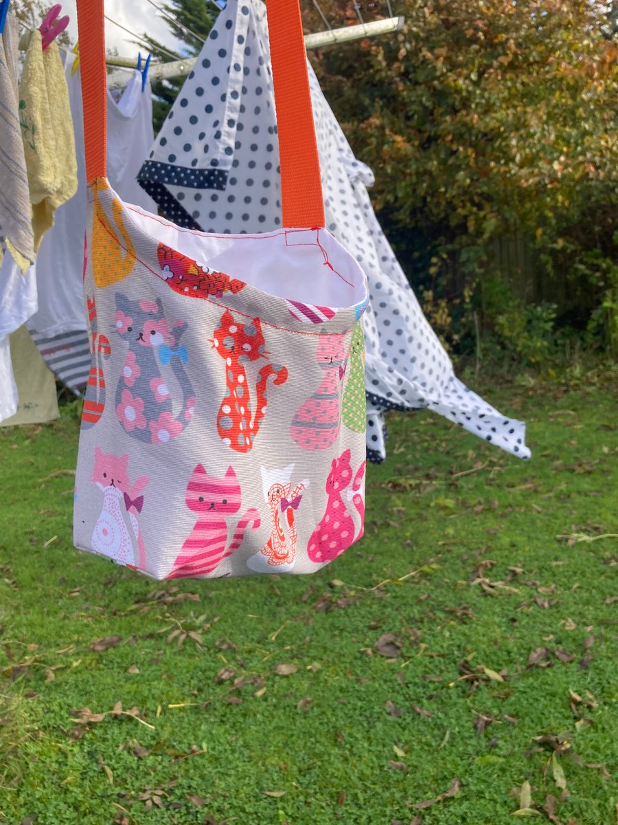 Peg bag. Shoulder, cross-body style  with orange strap and colourful cats