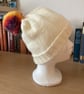 WOMENS HAND KNITTED BEANIE HAT IN CREAM YARN WITH A BOBBLE.