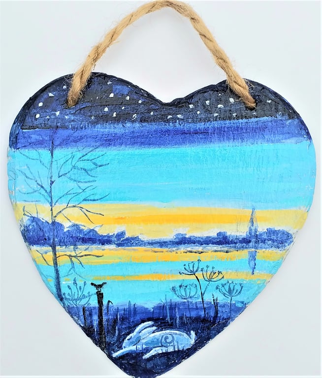 Hare snoozing beside a sunset river  on slate