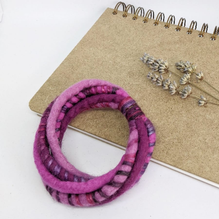 Felted cord bracelet in deep pink shades