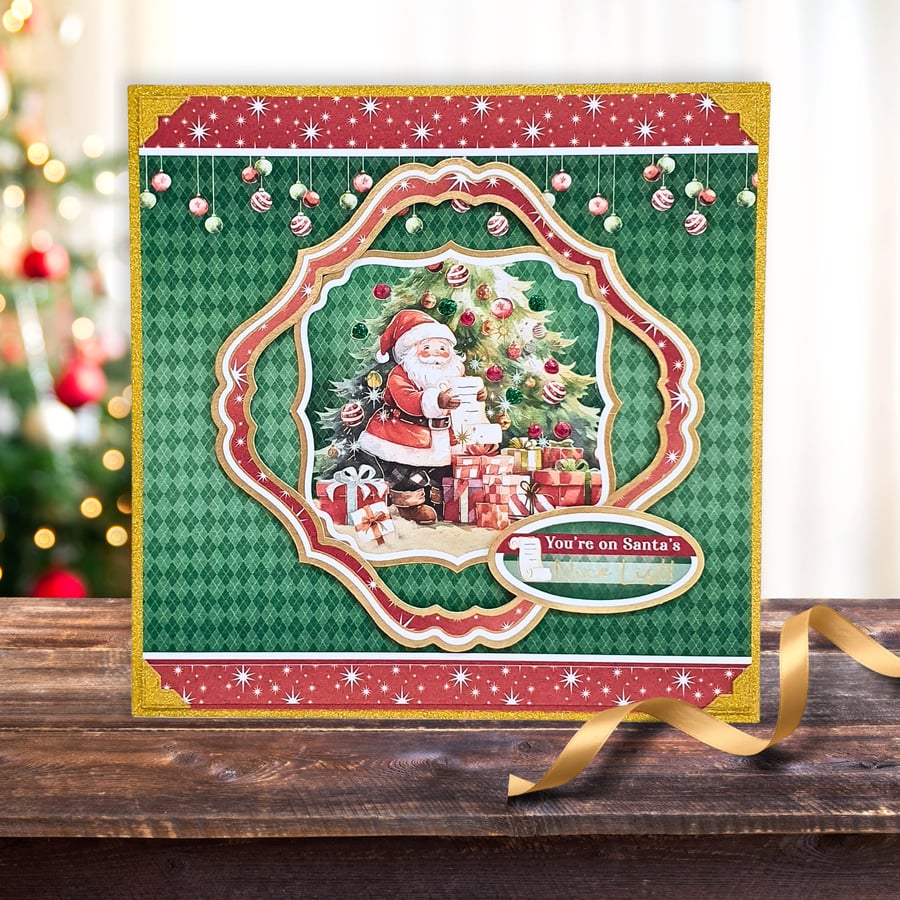 Christmas Card With Father Christmas Checking His List In Front Of An Xmas Tree