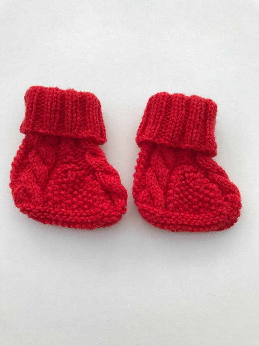 hand knitted baby bootees with cables