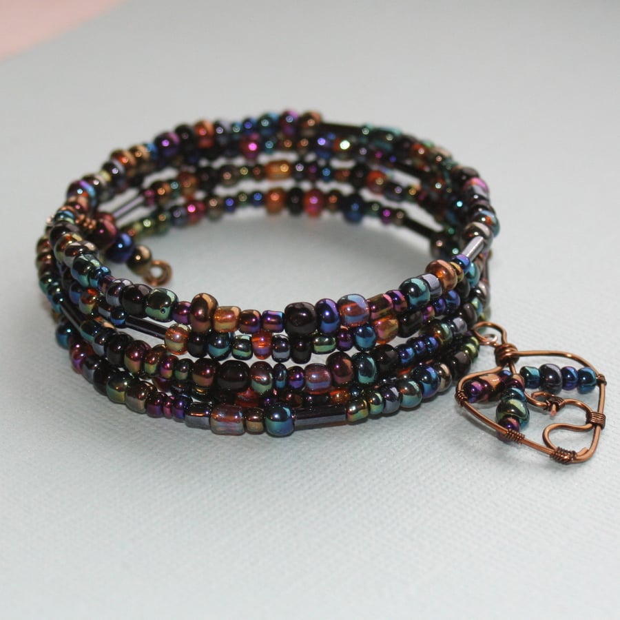 Multicoloured metallic beaded memory wire bracelet with wire wrapped charm
