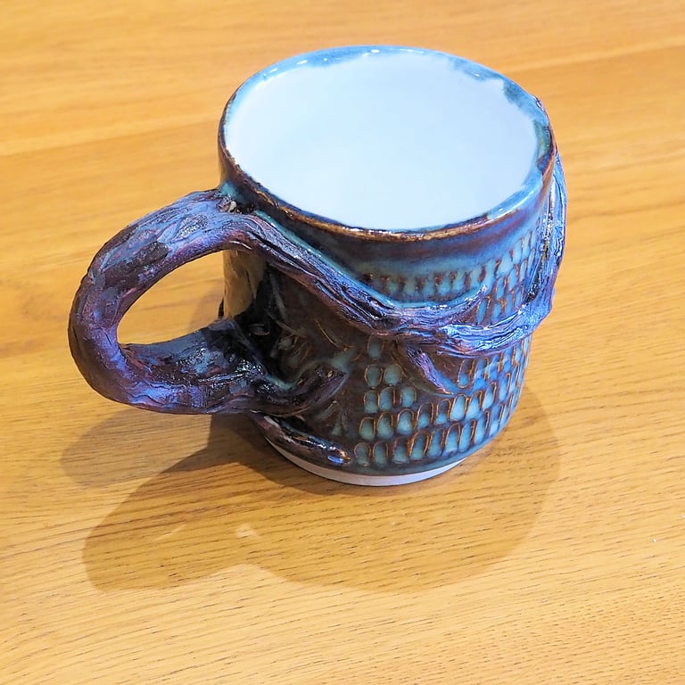 Pottery tree mug finished in blue and brown bark colour glazes