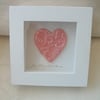 Ceramic pink heart impressed with a floral design.  Rustic white wood frame