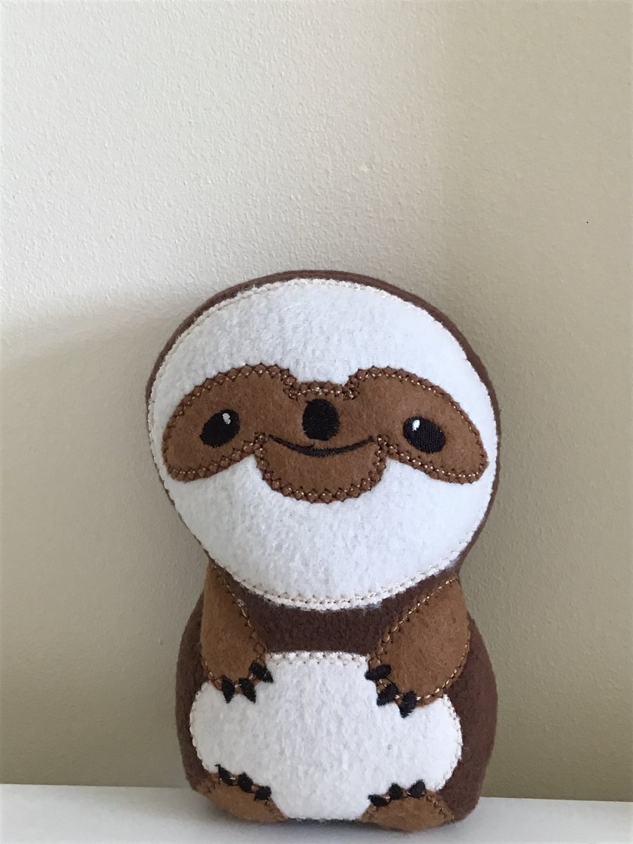 Brown sloth soft toy