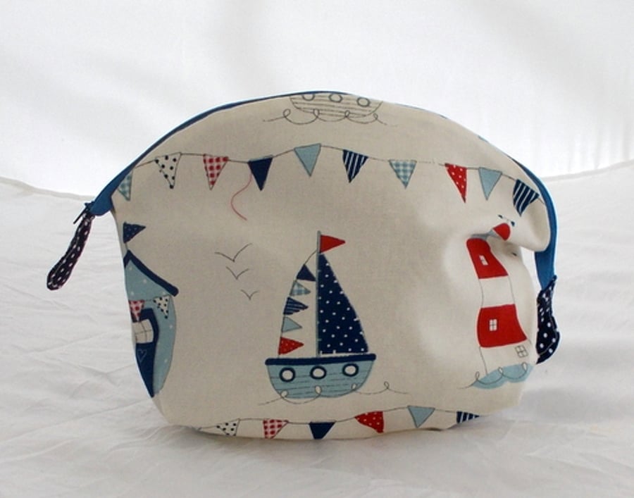 Toiletries bag printed with sail boats and light houses