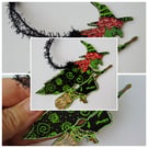 Flying Witch ornament by Kat Hazelton, black and green cape and dress. 