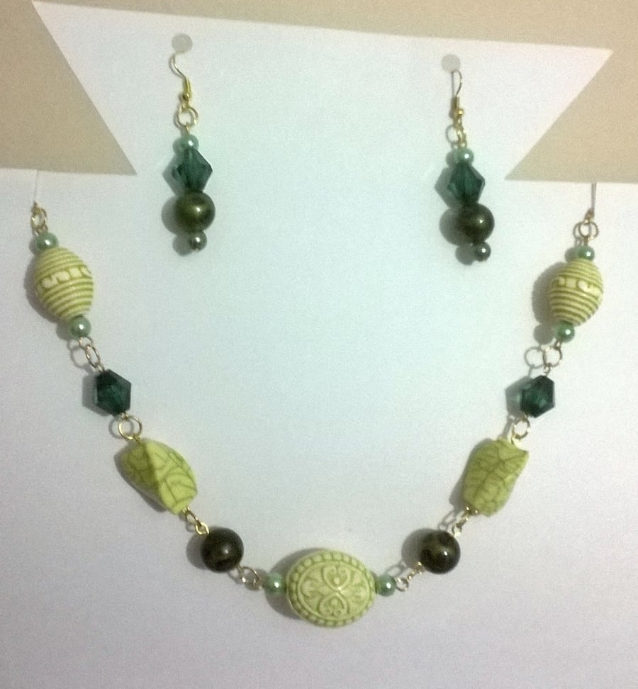 Multi shade green necklace and earrings set with gold plated findings.