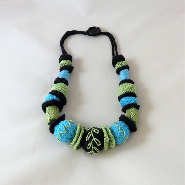 Bead string - knitted, crocheted, and fabric embroidered black, lime turquoise