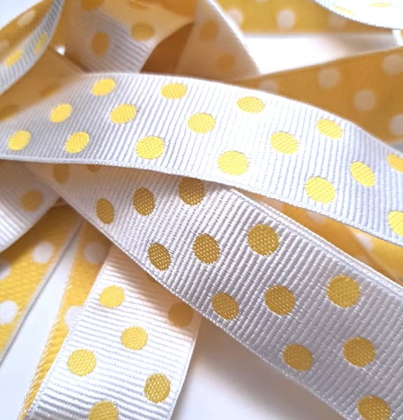 2.5 metres of yellow and white spotty ribbon, 25mm wide