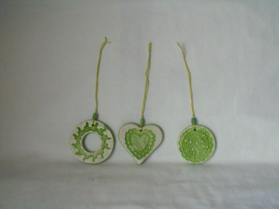 set of three impressed ceramic hanging decorations in green