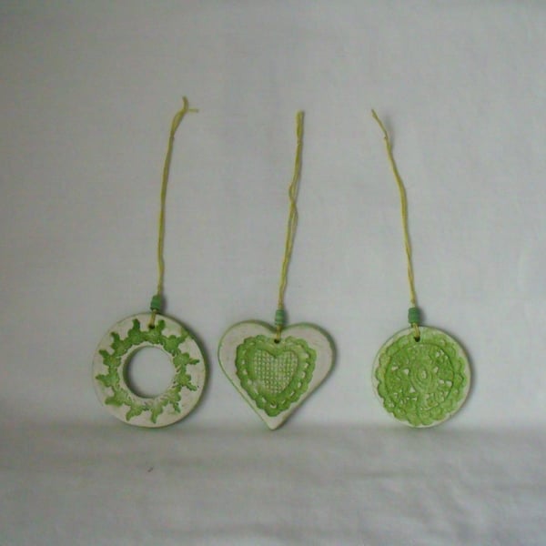 set of three impressed ceramic hanging decorations in green