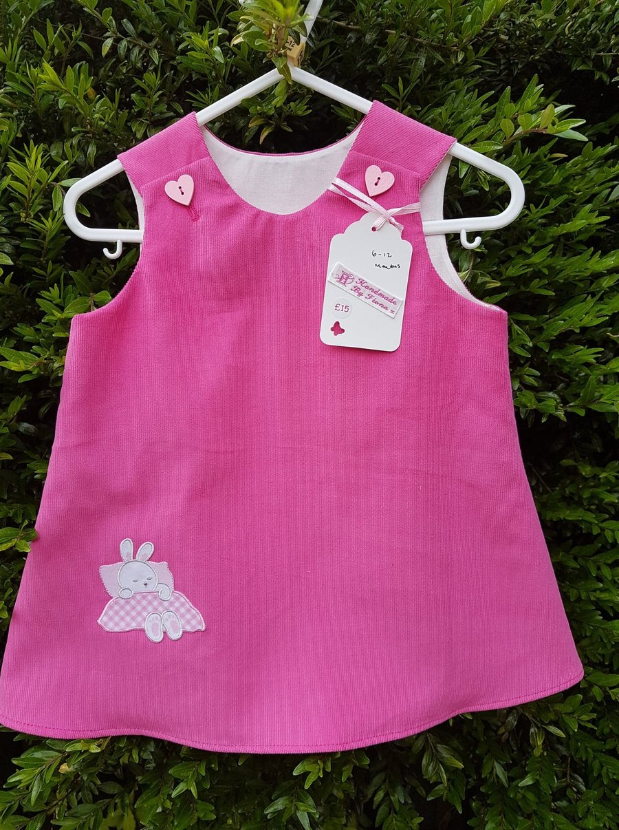Age: 6-12m. Rose pink baby needlecord pinafore dress. 