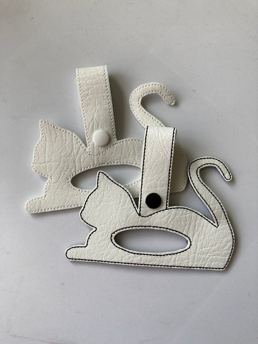 176. Laying cat tea towel holder.