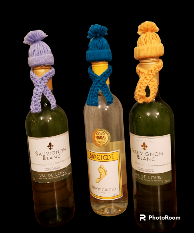 Crocheted bobble hat and scarf bottle toppers