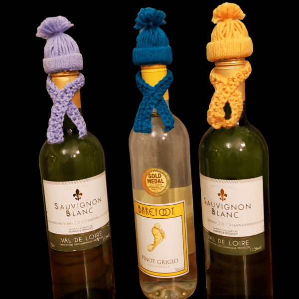 Crocheted bobble hat and scarf bottle toppers