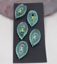 5 Small Leaf Shaped Emerald Green Ceramic Buttons - Image 1