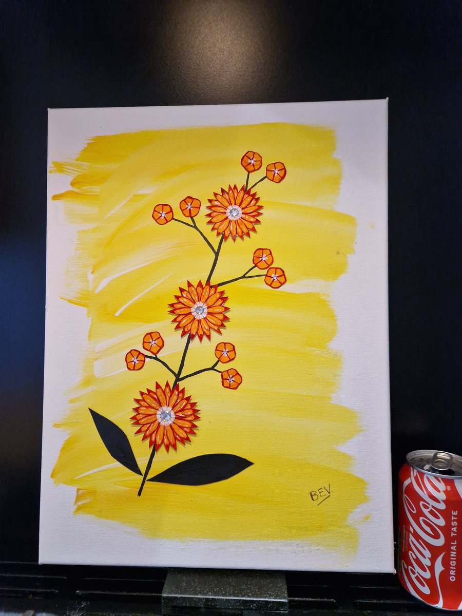  A handcrafted collage of orange flowers with an abstract yellow background. 