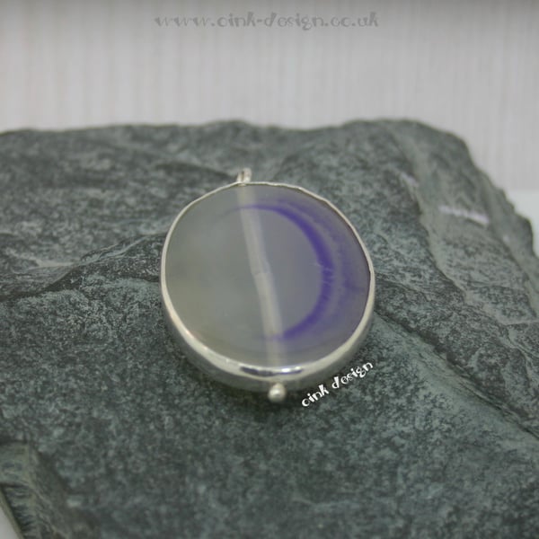 A slice of mauve agate set in sterling silver spectacle setting