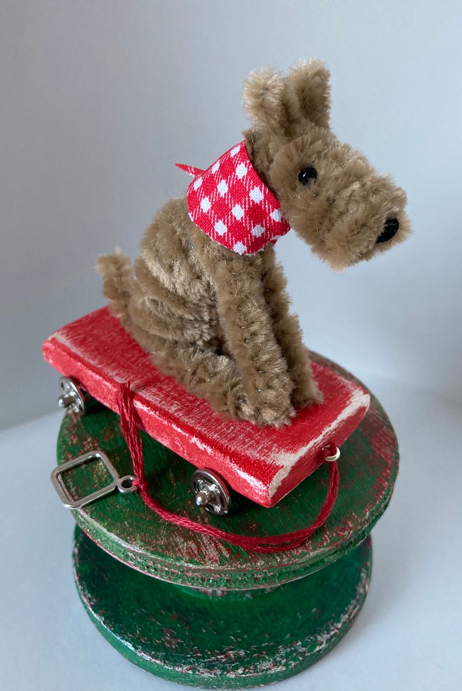Miniature Terrier on a Pull Along Trolley with Wheels. 