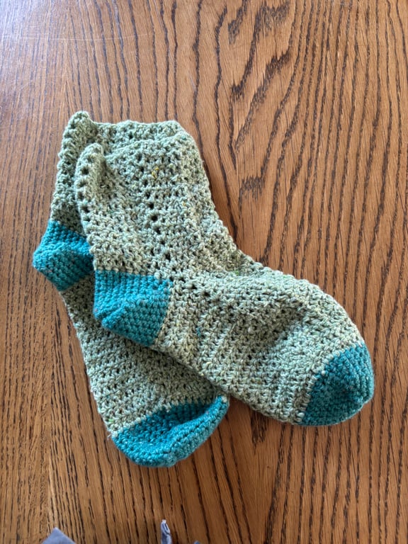 Pair of crochet green and teal socks made using recycled wool blend yarn, size 4
