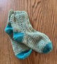 Pair of crochet green and teal socks made using recycled wool blend yarn, size 4
