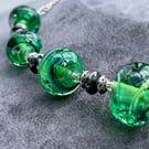 green swirly and sparkly handmade lampwork glass necklace