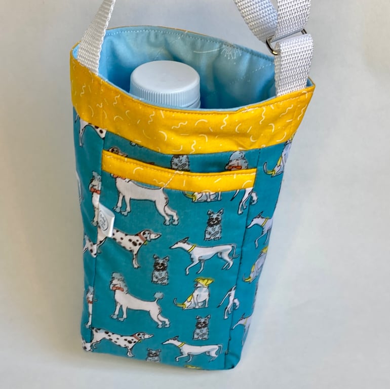 Water bottle carrier with key clip and pocket for phone. Turquoise dogs.