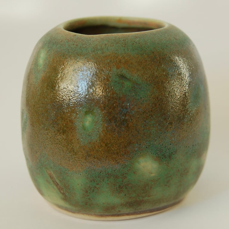Tiny green studio pottery vase with metallic glaze