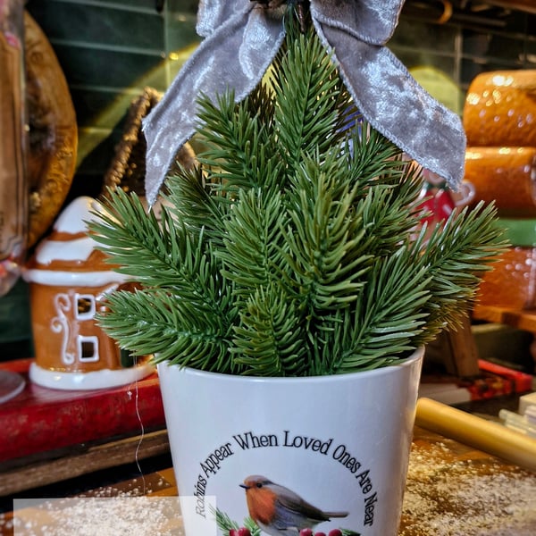 Robins appear when loved ones are near faux tree & pot  