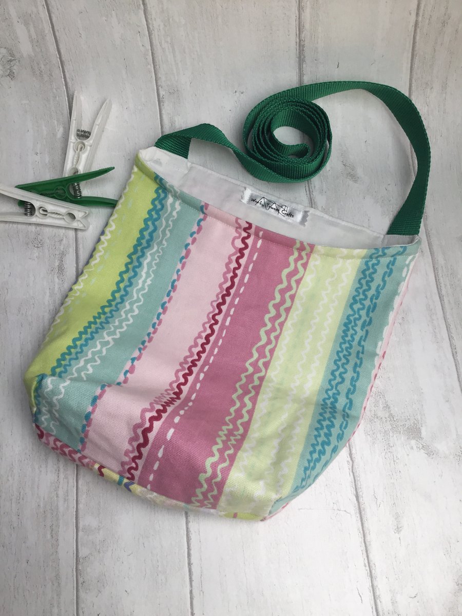 Shoulder strap peg bag for easy laundry hanging. Pastel stripes.