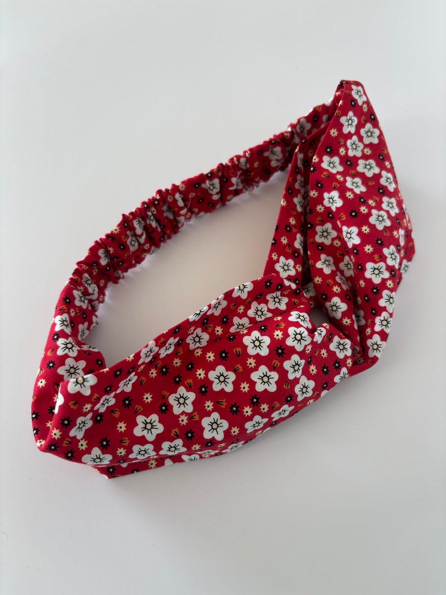Cotton headband, twist knot style hairband in a red and white floral print.