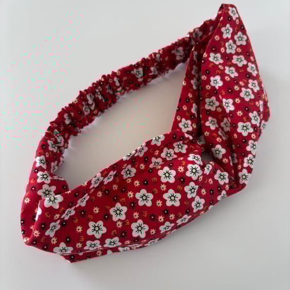 Cotton headband, twist knot style hairband in a red and white floral print.