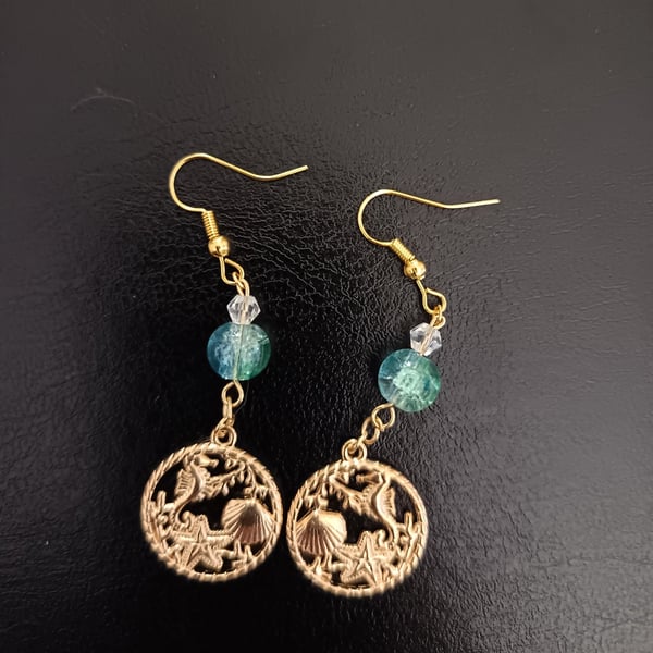 Gold beaded dangle earrings with nautical themed charms 