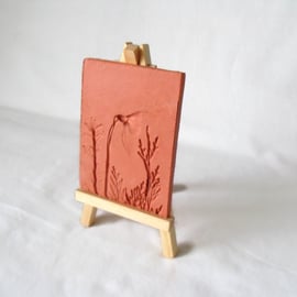 terracotta impressed clay tile displayed on an easel, number 3 of 8 available