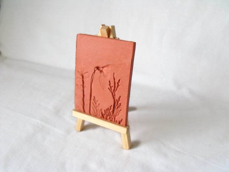 terracotta impressed clay tile displayed on an easel, number 3 of 8 available