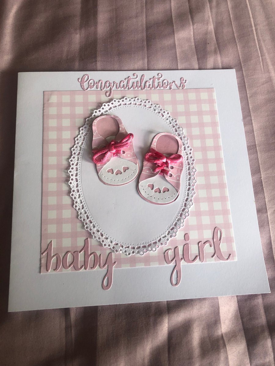 Baby girl pink card for arrival of new baby with cute little booties 