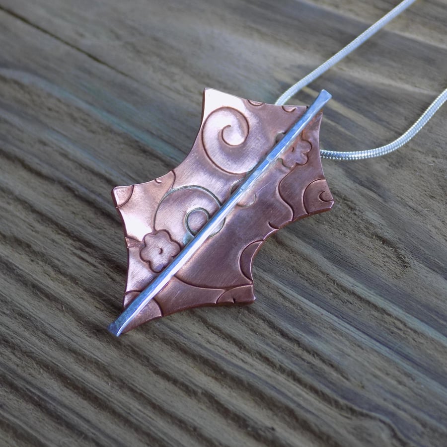 Copper patterned stylised holly leaf pendant 