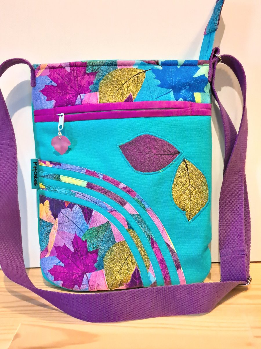 Colorful leaves on turquoise handbag 