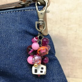 Bag charm with pink lamp work and agate beads and a ceramic house charm 