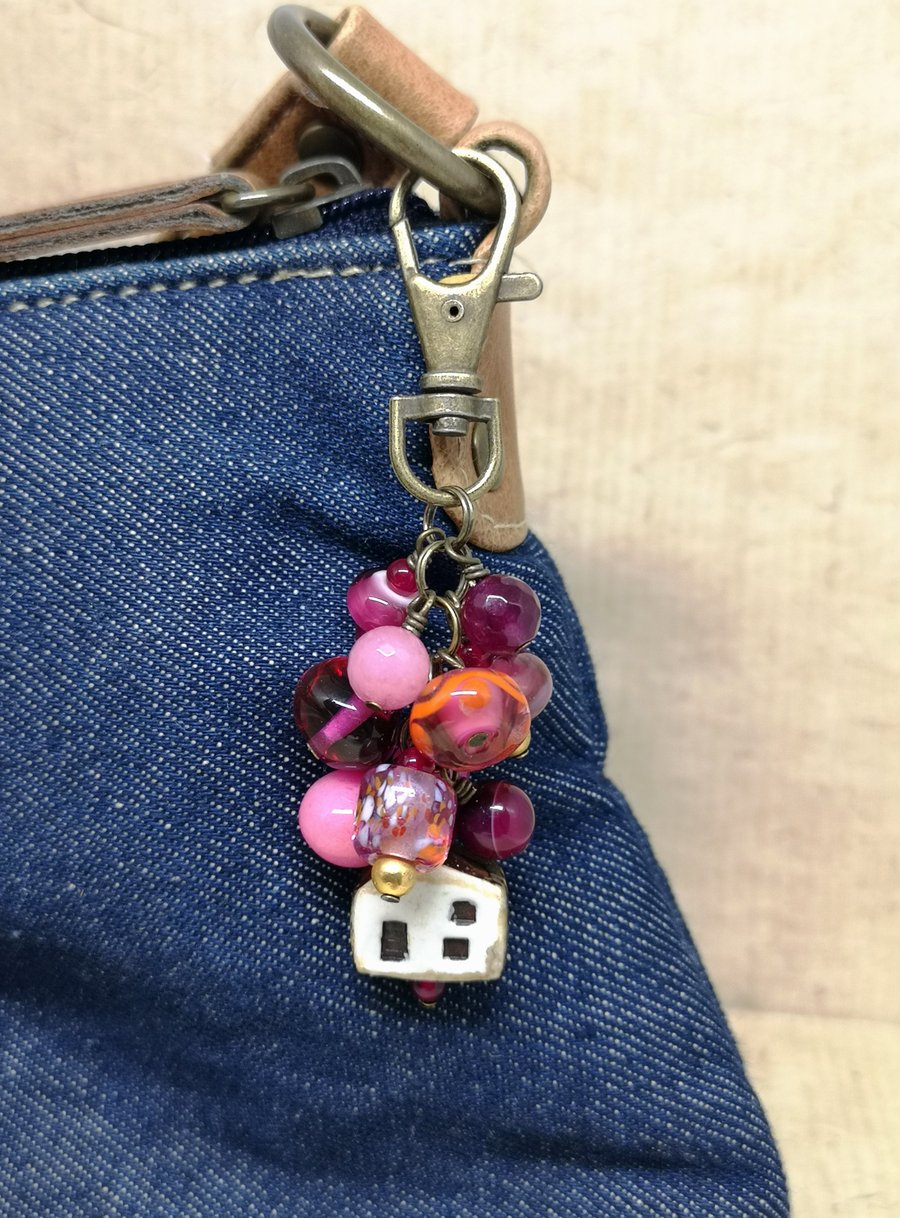 Bag charm with pink lamp work and agate beads and a ceramic house charm 