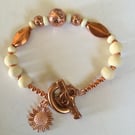 Copper and sandalwood beaded bracelet with sunflower charm