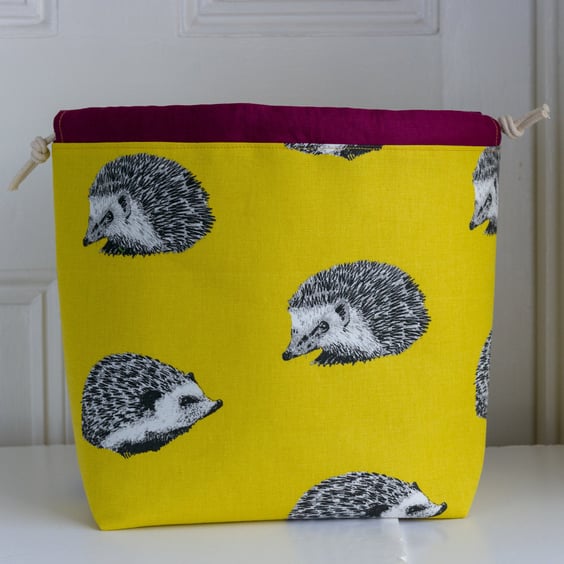 Large drawstring project bag featuring hedgehogs in bright yellow