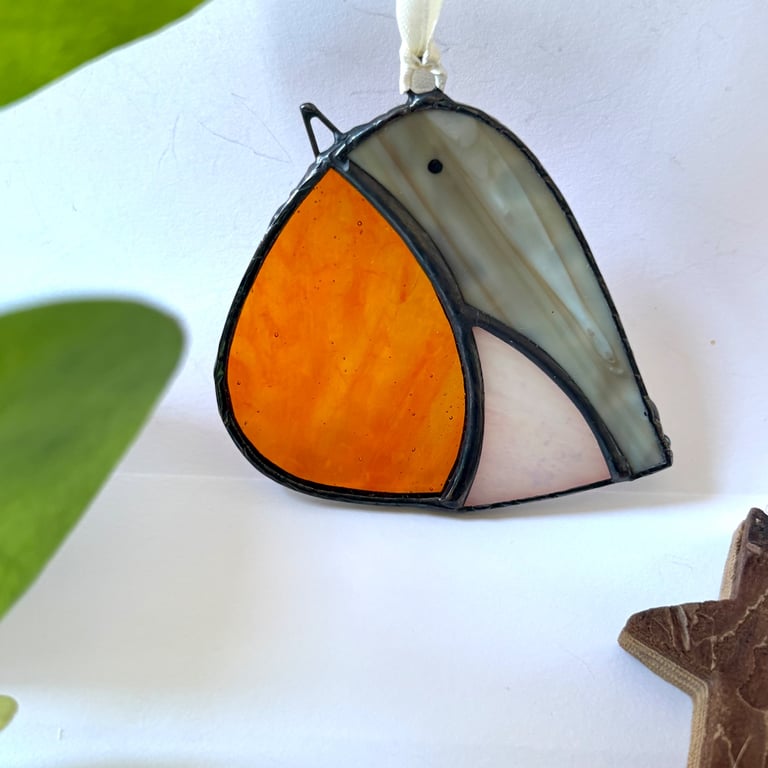 Stained glass robin suncatcher in a black patina finish suspended on a ribbon