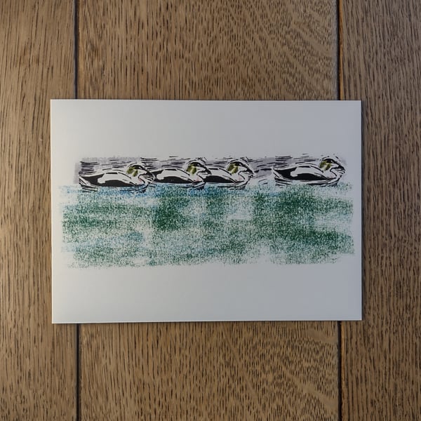 Four Eiders bobbing on the skyline, original design made using hand-cut stamps
